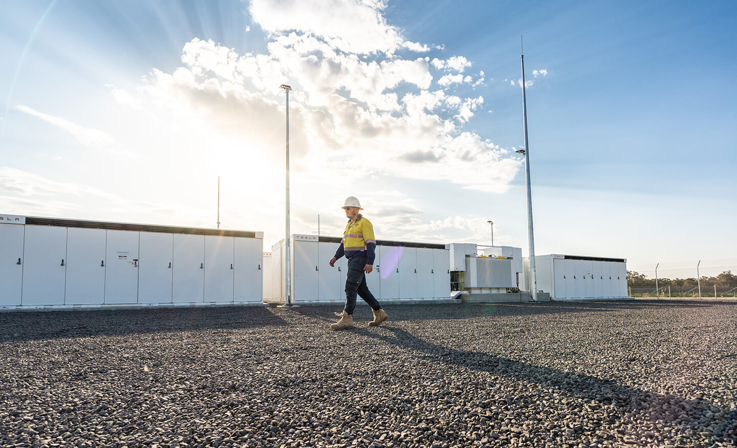 Person walking through solar battery farm